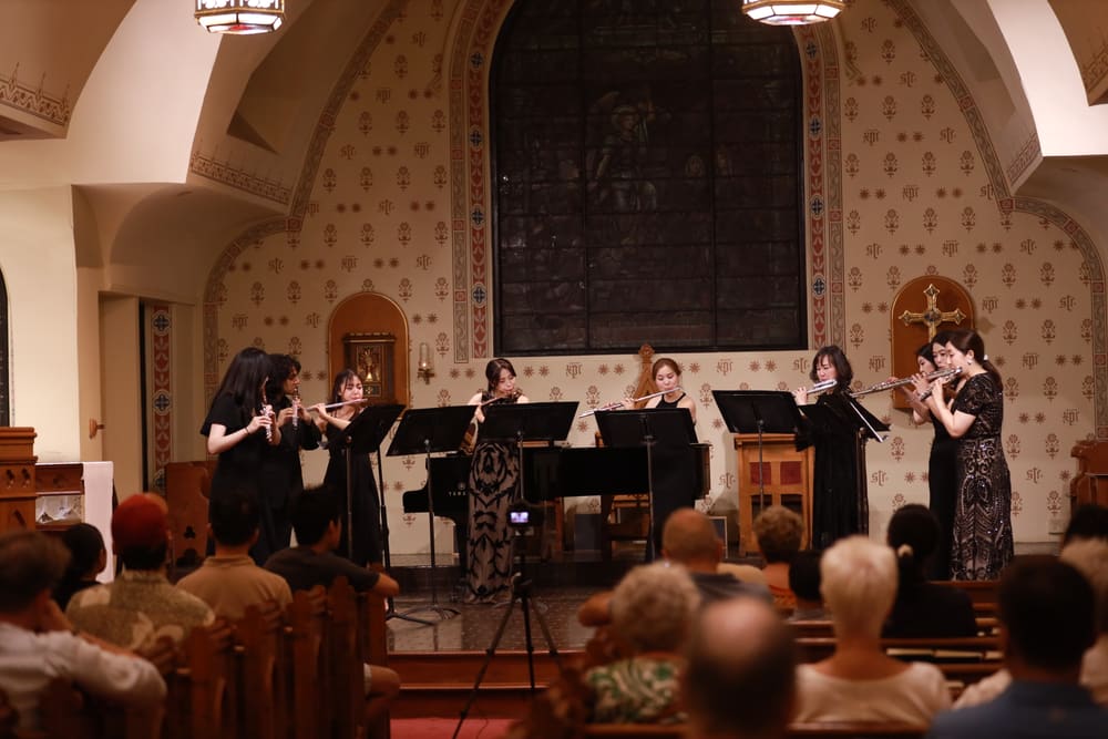 A flute ensemble performing in a church